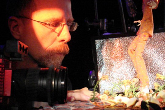 Person taking pictures of clay figure