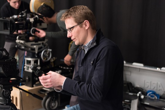 Man in a film studio sits down