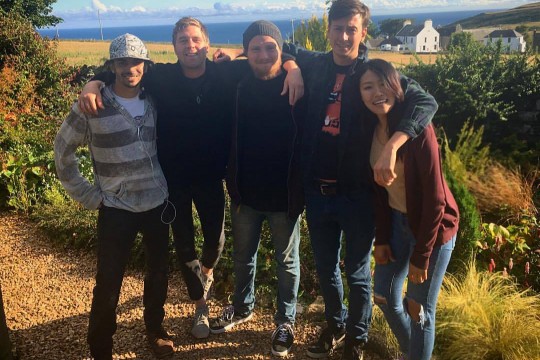 Group of 5 people pose for photo.