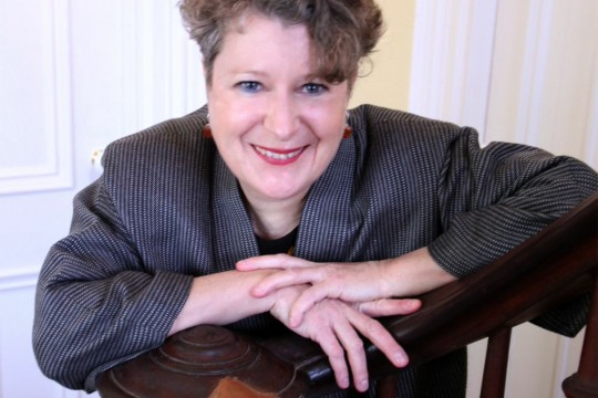 Wanda leaning against a railing