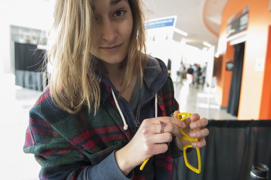 Women holds glasses while looking at the camera