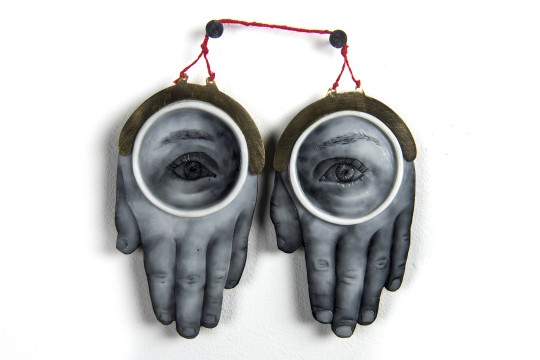 A sculpture of two hands with eyes on them.