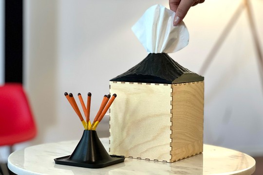 a volcano-shaped tissue dispenser and matchstick holder.