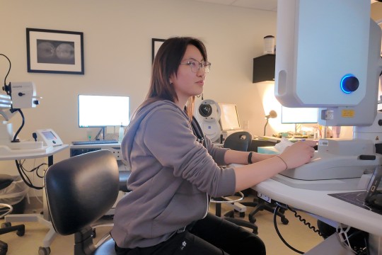 Melanie Ng operates ophthalmic imaging equipment.