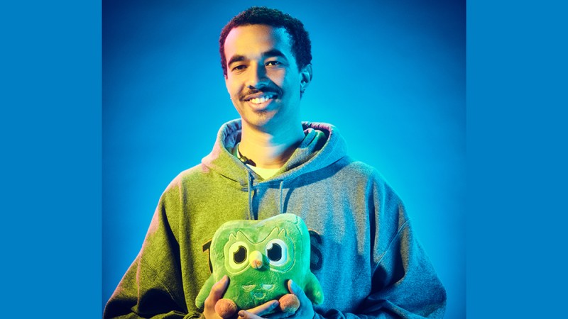 TJ Hampton portrait set against a blue background.
