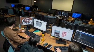 An overhead view of students working in a computer lab.