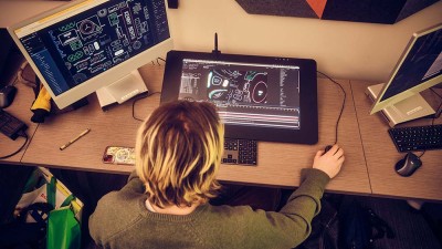 An overhead view of a student looking/working at a Cintiq.