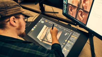 a student draws a 3 D image of a human ear.