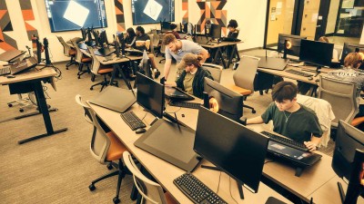 another view of the classroom with students at workstations.