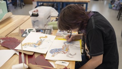 A student draws a carousel horse.