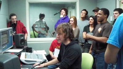  A group of students recording in the audio control room