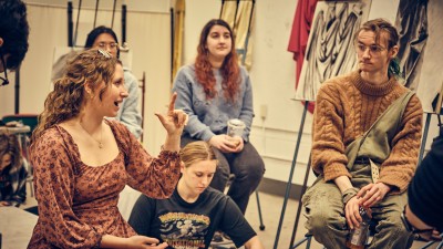 Students discuss artwork during a critique.