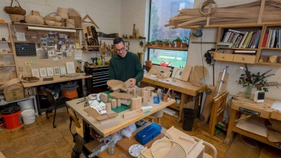 Graduate student working in a woodworking shop.