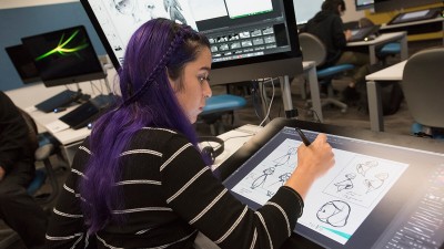 a student draws on a tablet.