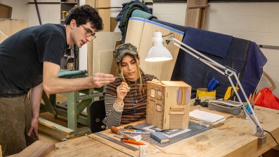 Two RIT furniture design students work on a project together.
