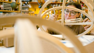 RIT furniture design's Hannah Giancola works in the program's graduate studio space, using hand tools.