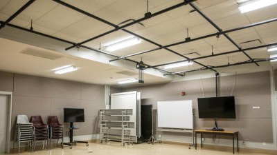 Empty sound room with sound proofing on the walls and tracks hanging from the ceiling