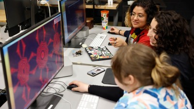 Three students collaborate on creating an animation.