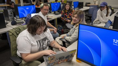 Students work at computers in a lab.