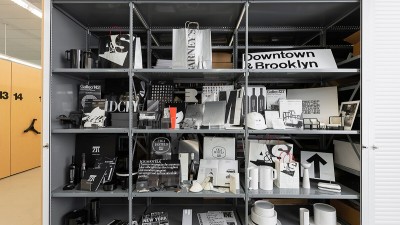 A display of artifacts from the Vignelli Center archives, including signs and product prototypes.
