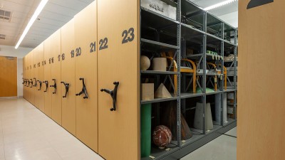 numbered archive shelves with large handles on the end to move the displays.