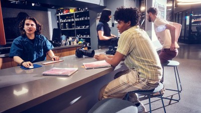 A Cage employee checks out equipment for a student.