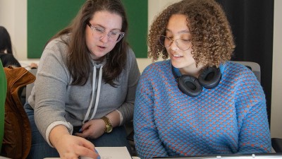 Faculty Christine Banna helps a student. 