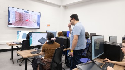Students work at computer stations.
