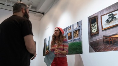 Two people talking inside William Harris Gallery. 