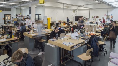 A wide shot of students working in the senior industrial design space.