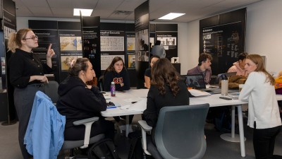 Students sit and talk at a table.
