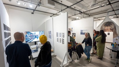 people talk to student artists in their gallery spaces.
