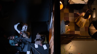 overhead view of the soundstage, with a wall dividing the scene on the right with the student crew filming on the right.