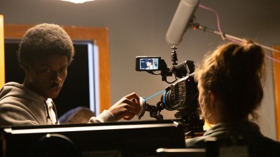 A student adjusts a camera. 