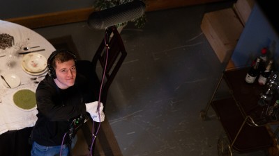 an overhead view of a student lifting up a boom mic.