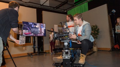 student operates a moving camera.