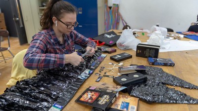 A student makes a wearable sculpture from Star Wars V H S tape.