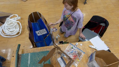 A student paints a design on a wearable sculpture in the Foundations Studio Labs.
