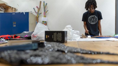 A student paints in a studio space.