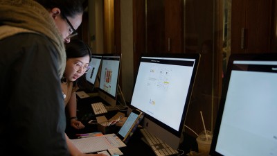 two students working at a computer.