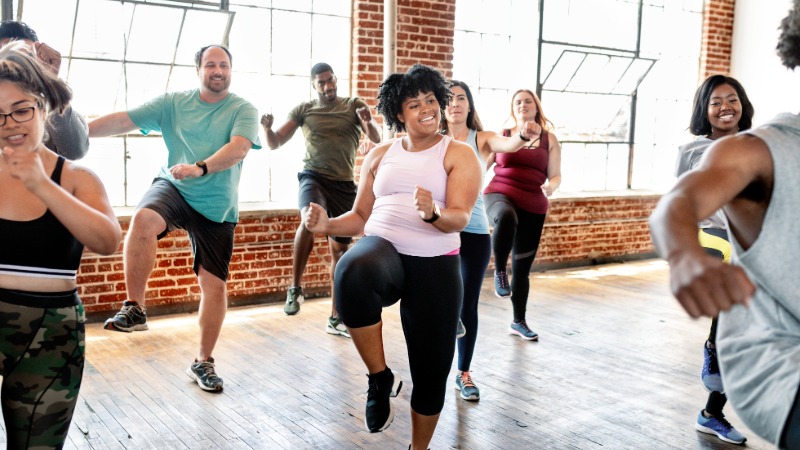 A group of people exercising together in a fitness studio.