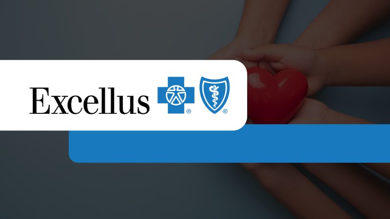 Four hands holding a red heart