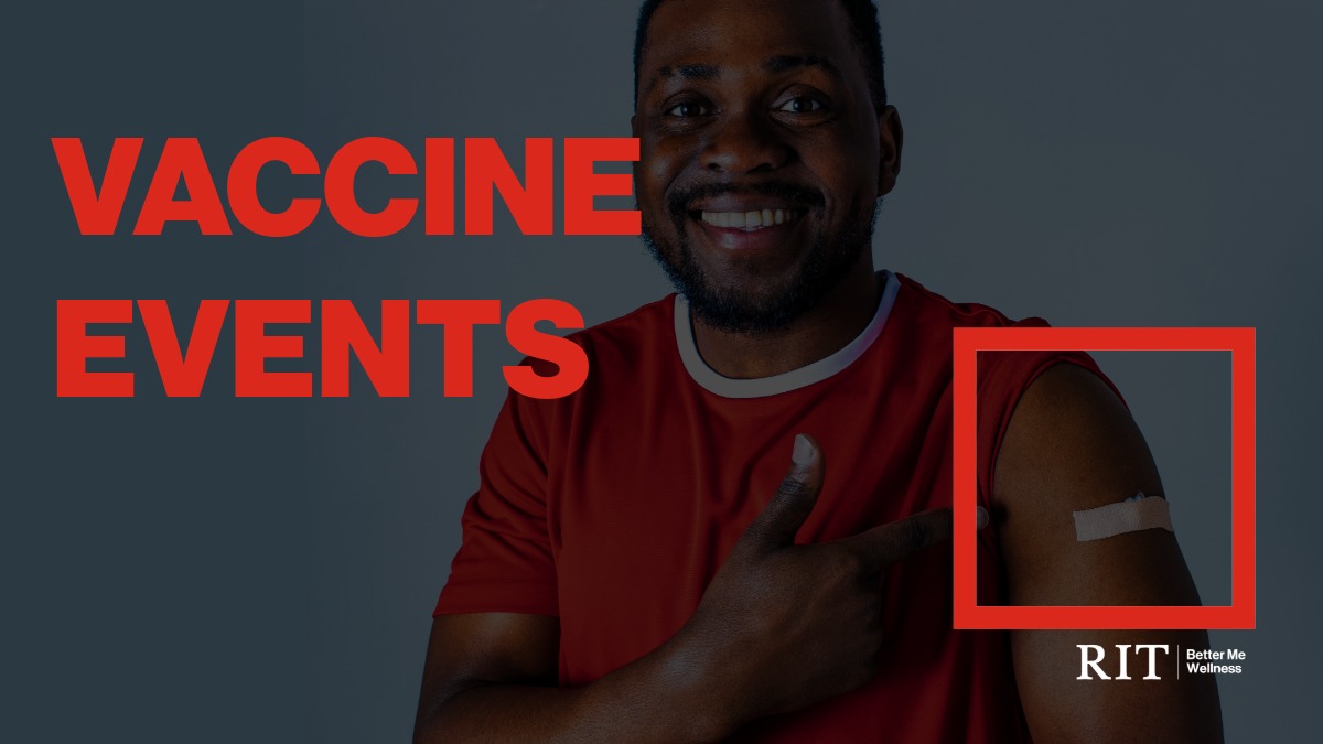 A smiling man in a red shirt showing off his bandage from a flu shot.