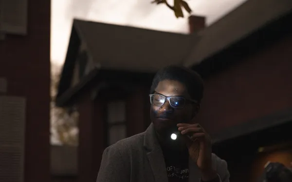 A volunteer points a flashlight.