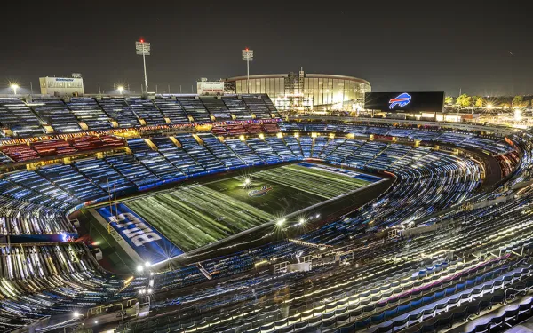 Bills stadium lit up at night by thousands of flashlights.
