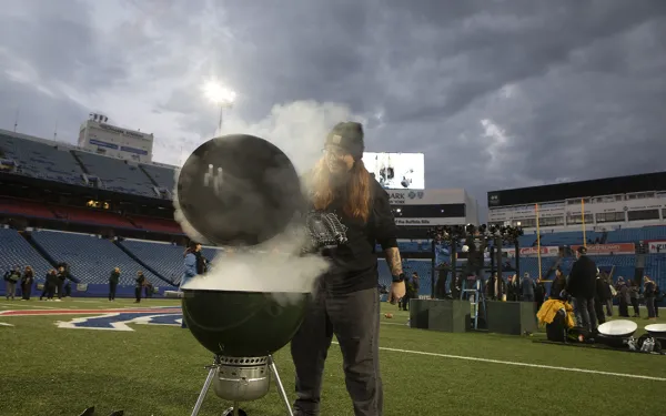 A person operates a smoke machine inside a grill as part of a Big Shot prop.