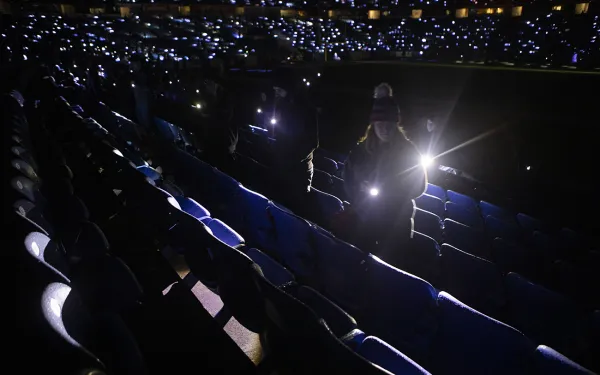 Big Shot volunteers paint with light in the stands.