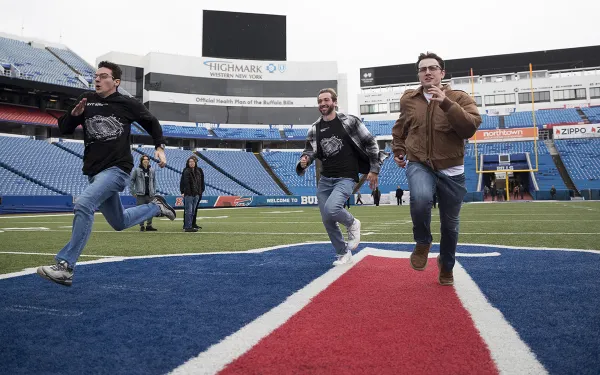 Students run on the Highmark Stadium field. Photo by Rebecca Villagracia '26