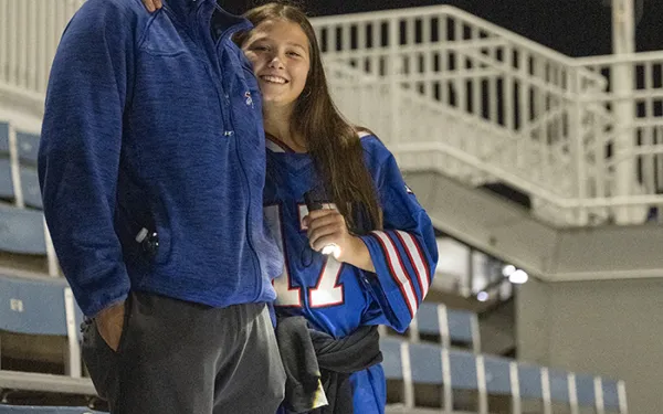 Two Big Shot participants smile in the stands.