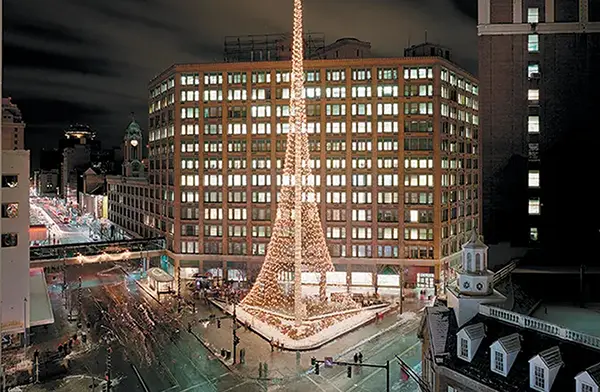 a lit up tower in a downtown area